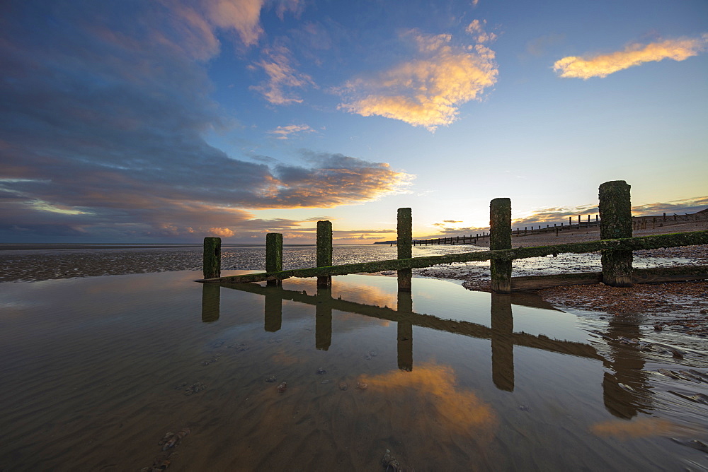 Rotting upright wooden posts of old sea defences on Winchelsea beach, Winchelsea, East Sussex, England, United Kingdom, Europe