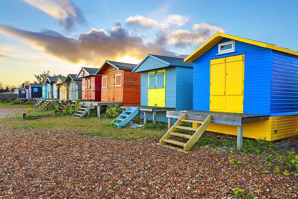 Colourful beach huts on shingle beach at sunrise, Whitstable, Kent, England, United Kingdom, Europe