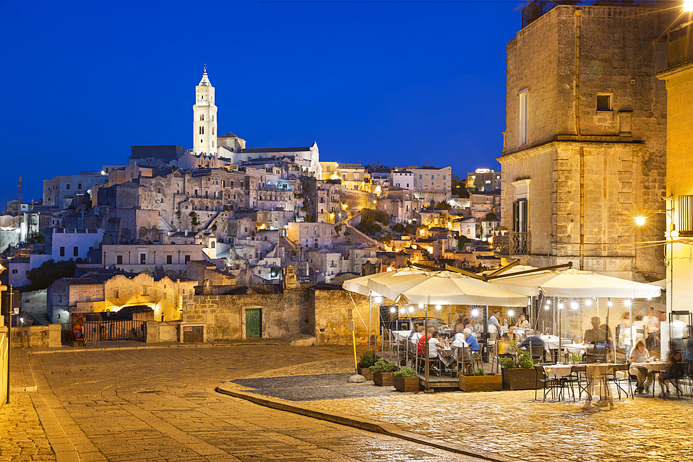 Restaurant at night with the Sassi di Matera old town floodlit, Via D'Addozio, Matera, Basilicata, Italy, Europe