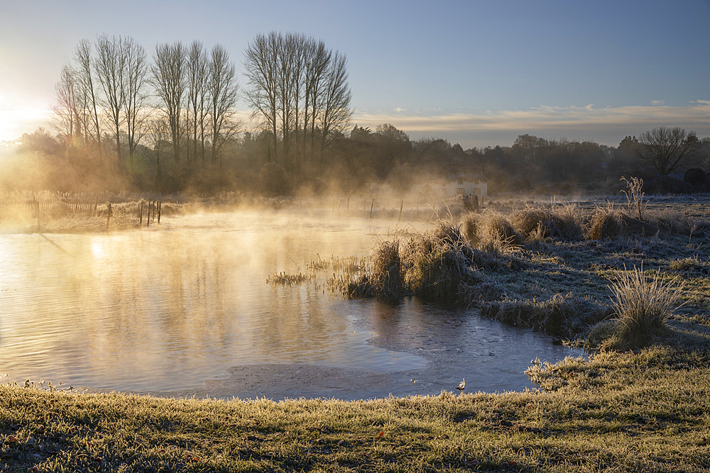 Frosty winter sunrise with mist on the River Test on Chilbolton Cow Common SSSI (Site of Special Scientific Interest), Wherwell, Hampshire, England, United Kingdom, Europe