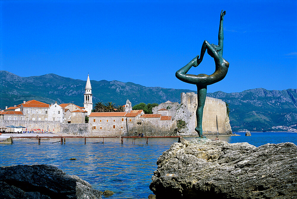 Statue and view of Old Town, Budva, The Budva Riviera, Montenegro, Europe