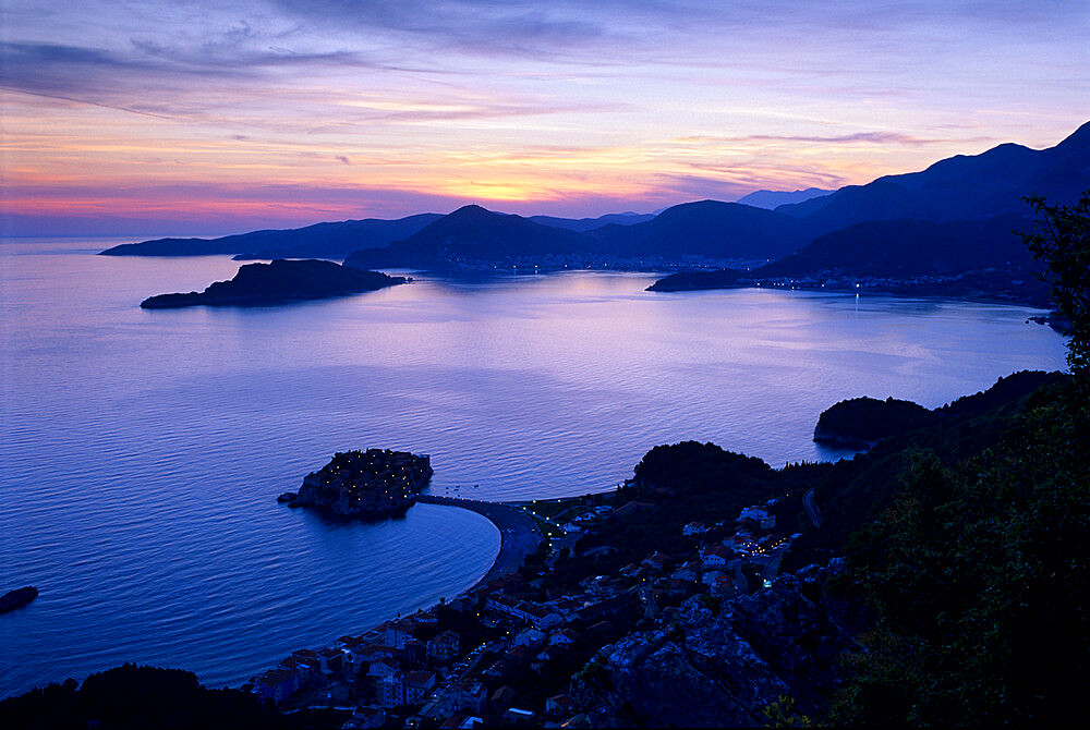 Sunset over Sveti Stefan and bay, Sveti Stefan, The Budva Riviera, Montenegro, Europe