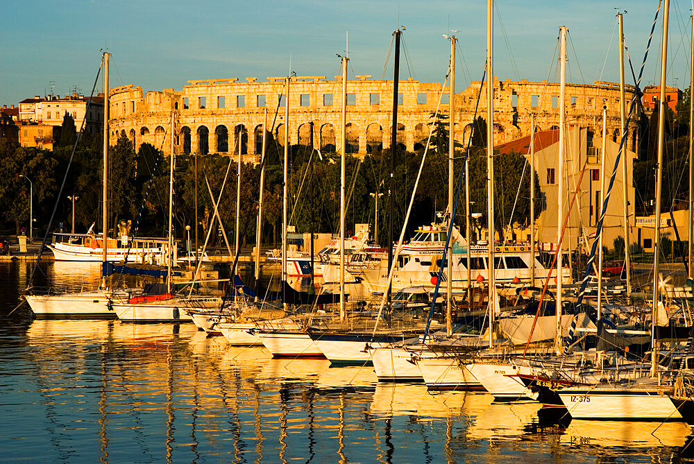 Sunset over marina to the Roman Amphitheatre, Pula, Istria, Croatia, Adriatic, Europe