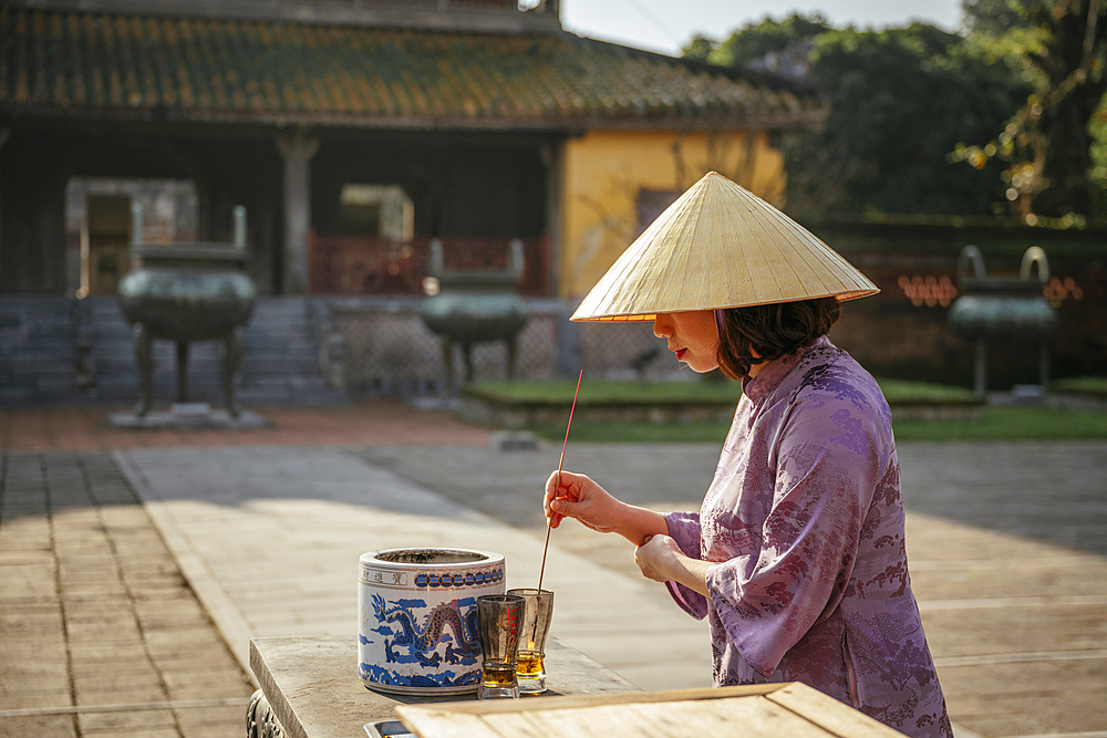 Woman making prayers at Buddhist Temple, Hue Historic Citadel, Hue, Thua Thien Hue, Vietnam