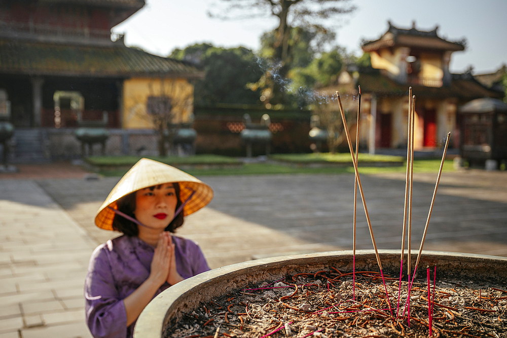 Woman making prayers at Buddhist Temple, Hue Historic Citadel, Hue, Thua Thien Hue, Vietnam