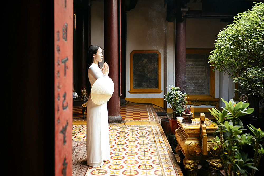 Vietnamese woman in ao dai at Quang Cong Temple, Hoi An, Quảng Nam Province, Vietnam