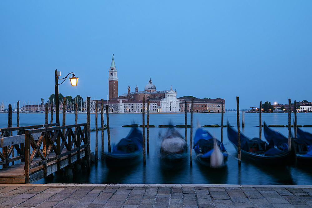 Goldolas on the lagoon at twilight, with San Giorgio Maggiore in the background, San Marco, Venice, Italy