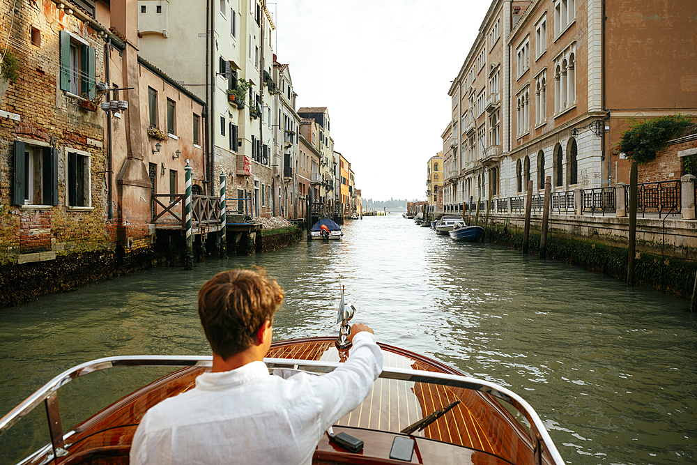 Speedboat water taxi through canals of Venice, Veneto, Italy