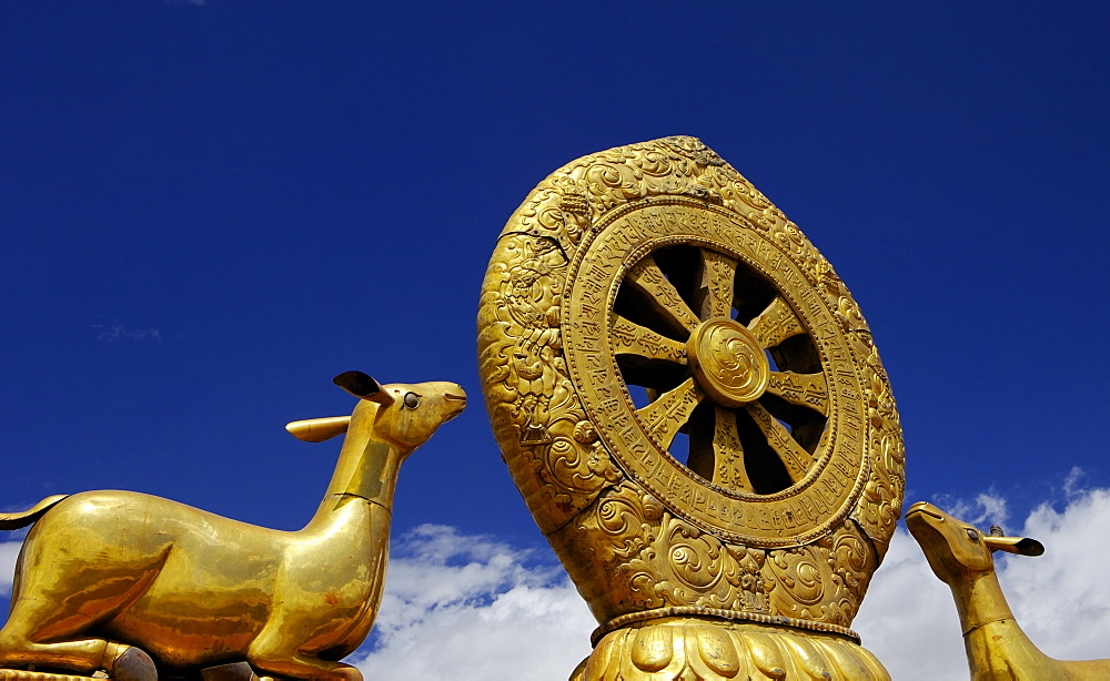 Golden Wheel of Dharma and deer sculptures on the sacred Jokhang Temple roof, Barkhor Square, Lhasa, Tibet, China, Asia 