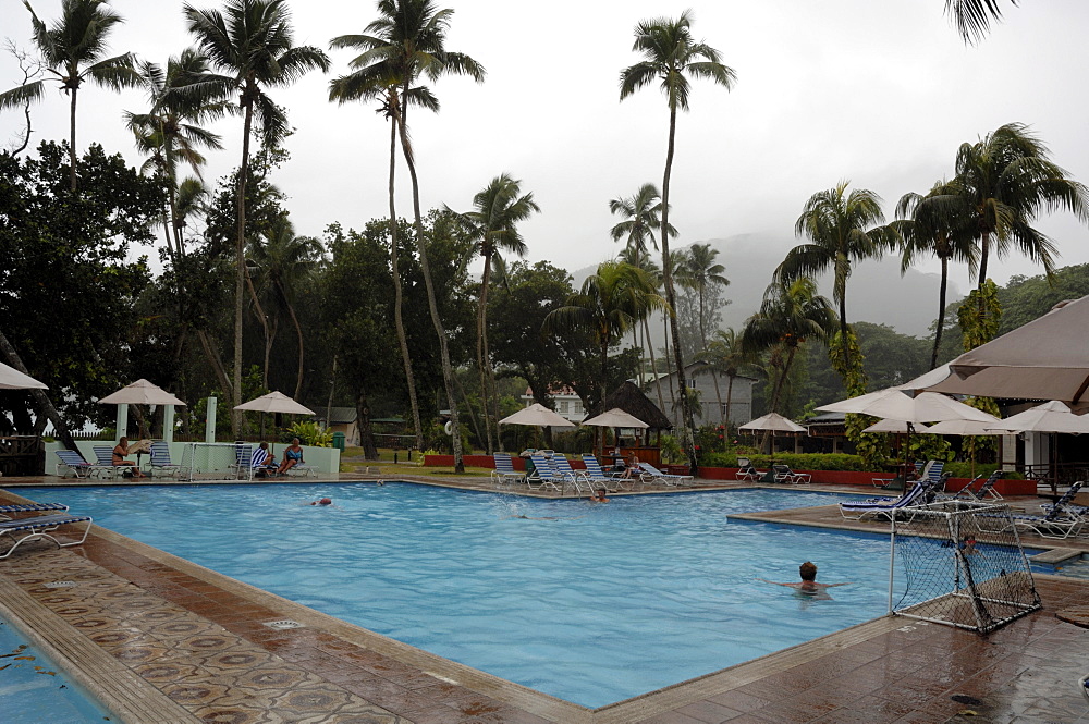 Swimming pool at Berjaya Beau Vallon Hotel during rain storm, Mahe, Seychelles, Indian Ocean