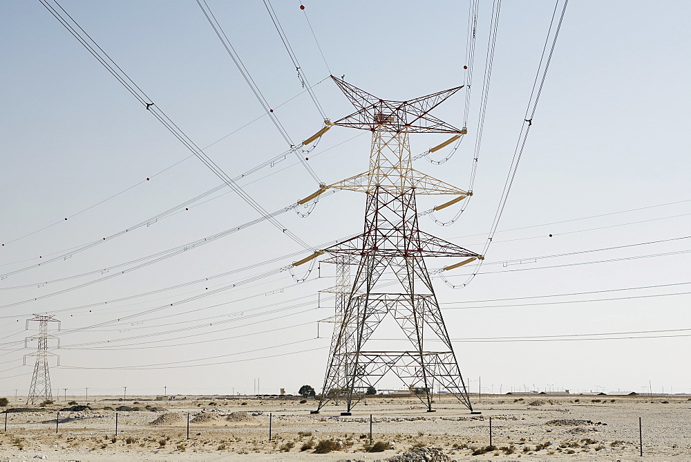 Electricity pylons dominate the desert skyline, Qatar, Middle East