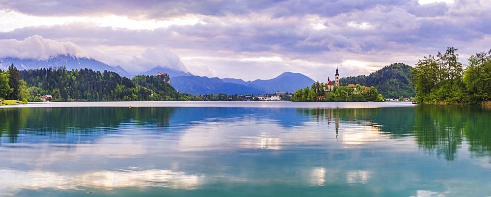 Lake Bled at sunrise with the Church on Lake Bled Island and Bled Castle, Gorenjska Region, Slovenia, Europe