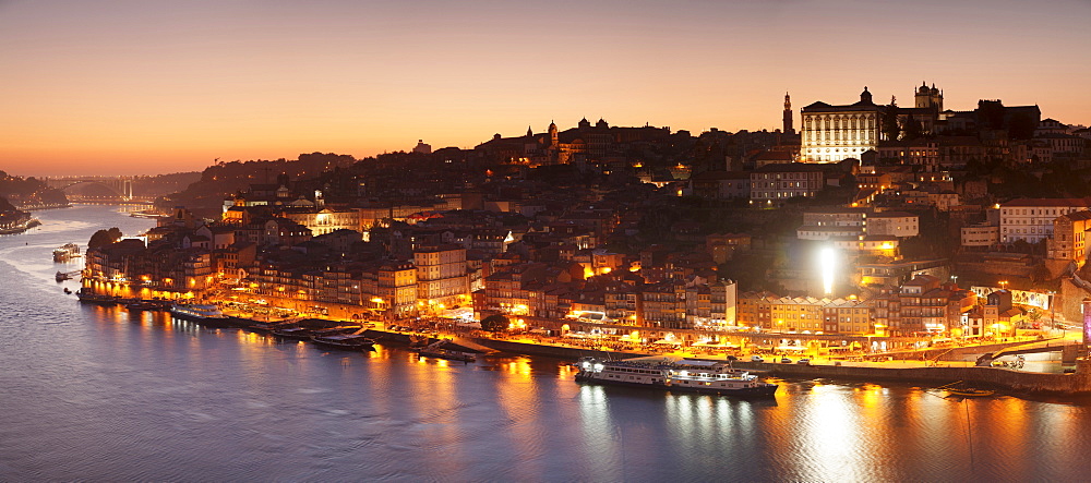 View over Douro River at sunset to Ribeira District, UNESCO World Heritage Site, Porto (Oporto), Portugal, Europe