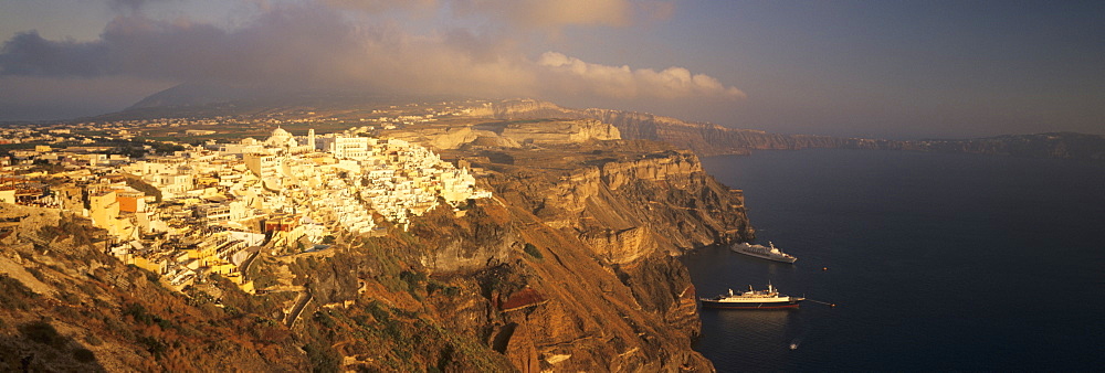 Panoramic image of Fira in the evening with cruiser and volcanic landscape, Santorini, Cyclades, Greek Islands, Greece, Europe 