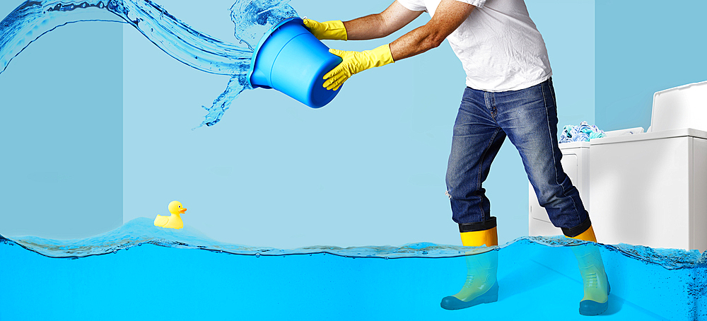 Man throwing water from bucket in flooding laundry room