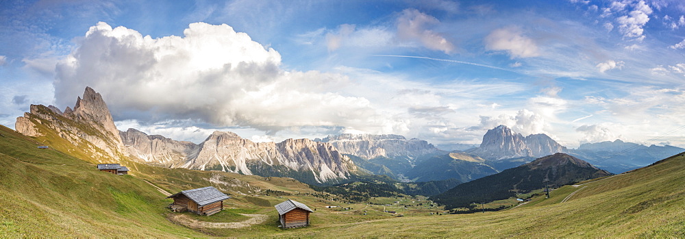 Panorama of green meadows and huts of the Odle mountain range seen from Seceda, Val Gardena, Trentino-Alto Adige, Italy, Europe