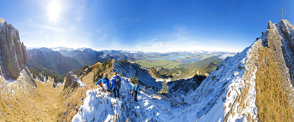 Climbers on steep crest covered with snow in the Ammergau Alps, Tegelberg, Fussen, Bavaria, Germany, Europe