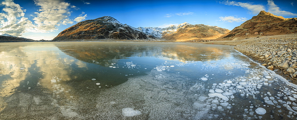 Panoramic of frozen lake Montespluga at dawn, Chiavenna Valley, Sondrio province, Valtellina, Lombardy, Italy, Europe