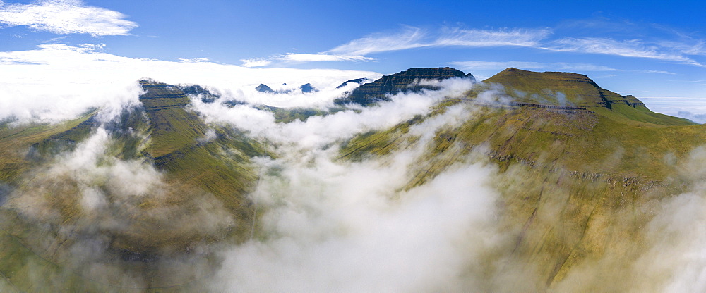 Panoramic aerial view of clouds on mountain peaks, Gjogv, Eysturoy island, Faroe Islands, Denmark, Europe