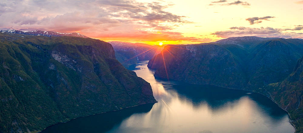 Aerial panoramic of dramatic sky at sunset along the fjord from Stegastein lookout, Aurlandsfjord, Sogn og Fjordane county, Norway, Scandinavia, Europe