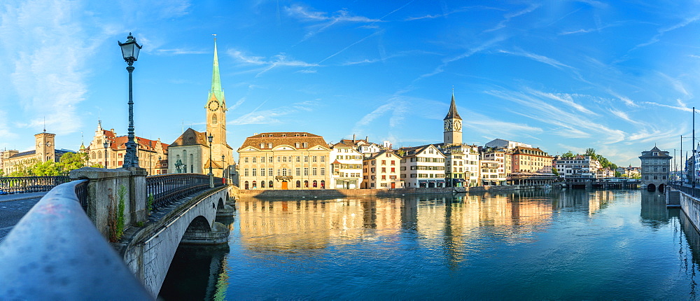 Panoramic of Fraumunster church and Limmat River seen from Munsterbrucke bridge at sunrise, Zurich, Switzerland, Europe