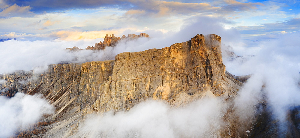 Aerial view by drone of sunset over Lastoi De Formin and Cima Ambrizzola in a sea of clouds in autumn, Giau Pass, Dolomites, Veneto, Italy, Europe