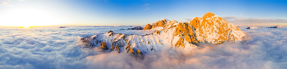 Panoramic aerial view of Grigne group mountain peaks emerging from mist at sunset, Lake Como, Lecco province, Lombardy, Italy, Europe