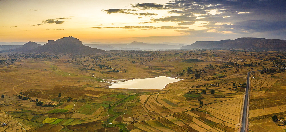 Aerial panoramic by drone of asphalt road crossing the inland area towards Gheralta Mountains, Dugem, Tigray Region, Ethiopia, Africa