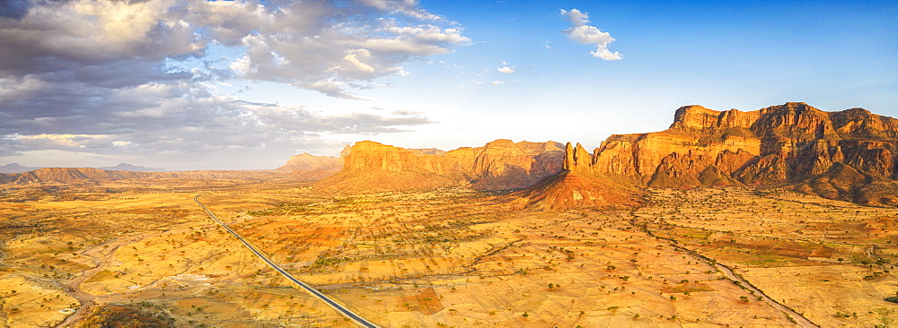 Aerial panoramic by drone of road at foot of Gheralta Mountains canyons, Hawzen, Tigray Region, Ethiopia, Africa