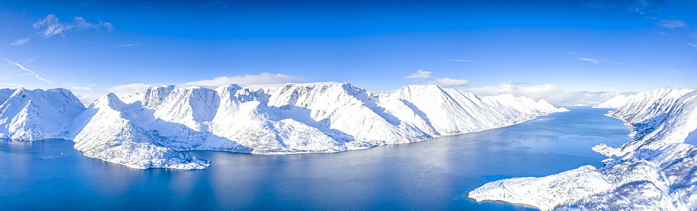 Aerial view of snow capped mountains and fjord during the cold arctic winter, Oksfjord, Troms og Finnmark, Northern Norway, Scandinavia, Europe