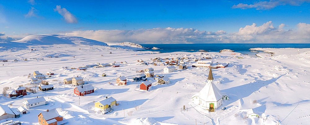 Aerial view of traditional houses and church in the small village of Hasvik after a snowfall, Troms og Finnmark, Northern Norway, Scandinavia, Europe