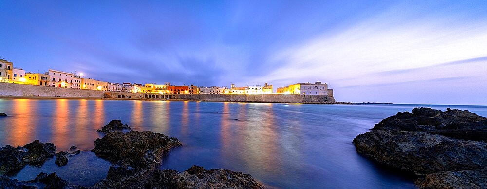 Clouds over Gallipoli washed by the Ionic Sea at dusk, Lecce province, Salento, Apulia, Italy, Europe