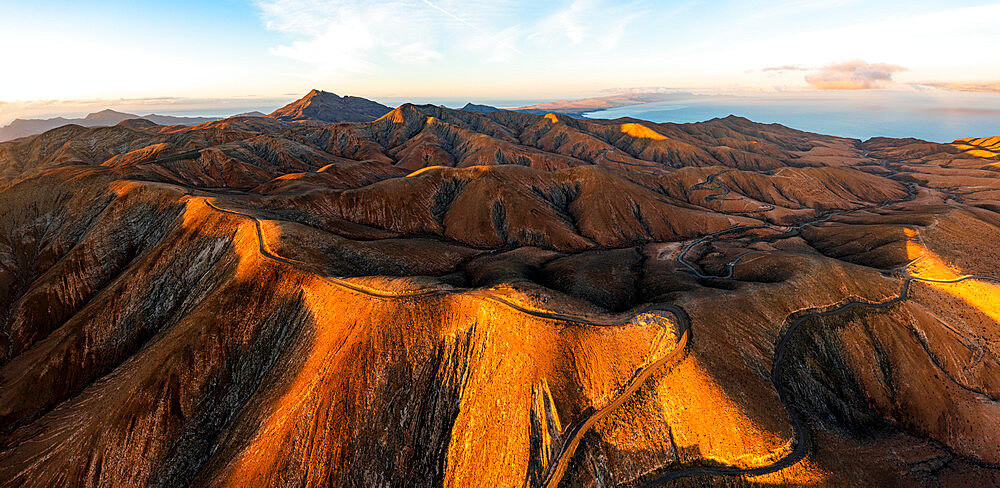 Empty road crossing the barren mountains of Pajara at dawn from Sicasumbre observatory, Fuerteventura, Canary Islands, Spain, Atlantic, Europe