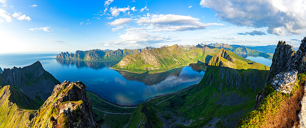 Aerial view of Husfjellet mountain and Devil's Teeth peaks reflected in the fjord at sunset, Senja, Troms county, Norway, Scandinavia, Europe