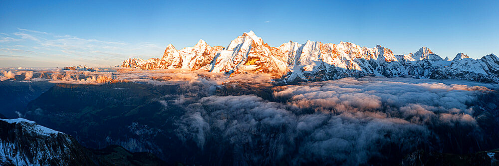 Foggy sky at sunset over majestic rocks of Eiger, Monch and Jungfrau mountains, Murren Birg, Jungfrau Region, Bern, Swiss Alps, Switzerland, Europe