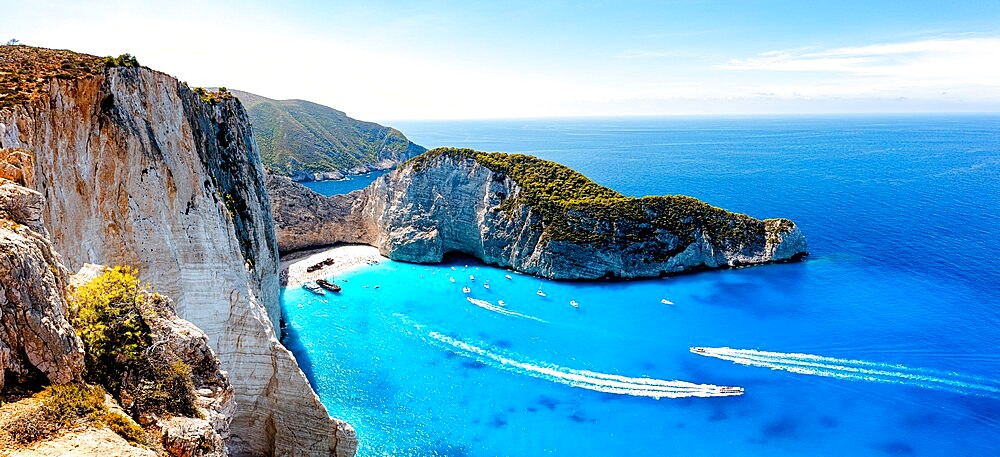 Ferry boats in the turquoise lagoon surrounding the iconic Shipwreck Beach (Navagio Beach), aerial view, Zakynthos, Greek Islands, Greece, Europe