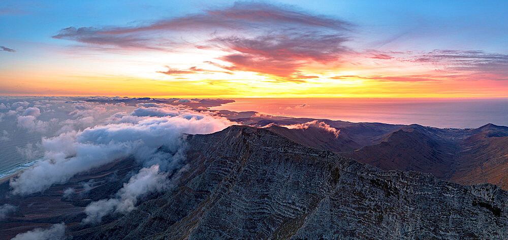 Burning sky at dawn over Pico de la Zarza mountain peak in a sea of clouds, Jandia, Fuerteventura, Canary Islands, Spain, Atlantic, Europe