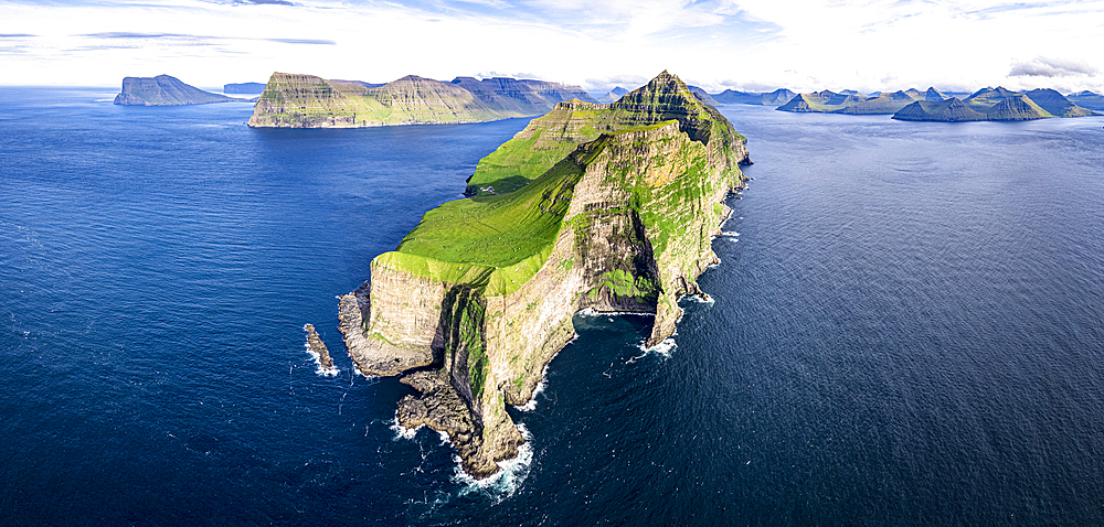 Aerial view of Kallur lighthouse on majestic cliffs washed by the blue Atlantic ocean, Kalsoy island, Faroe Islands, Denmark, Europe