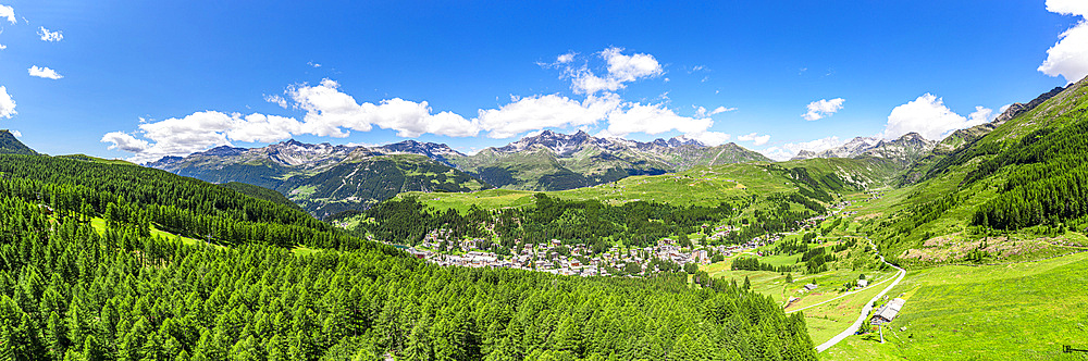 Aerial panoramic of the alpine village of Madesimo surrounded by green woods, Valle Spluga, Valtellina, Lombardy, Italy, Europe