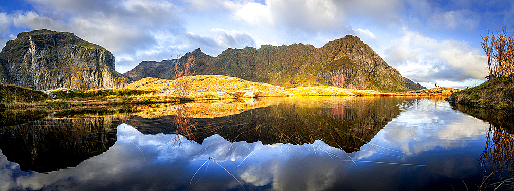 Panoramic of mountains reflected in the calm waters of a fjord at dawn, A i Lofoten, Moskenes, Lofoten Islands, Nordland, Norway, Scandinavia, Europe