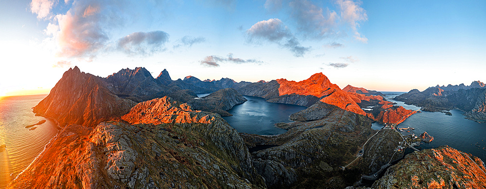 Idyllic lake framed by mountains overlooking the arctic sea at sunset, Moskenesoya, Lofoten Islands, Nordland, Norway, Scandinavia, Europe