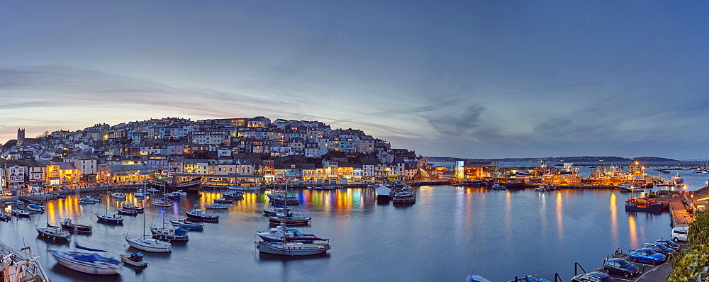 An atmospheric dusk view over the quintessential fishing harbour of Brixham, in Torbay, Devon, England, United Kingdom, Europe