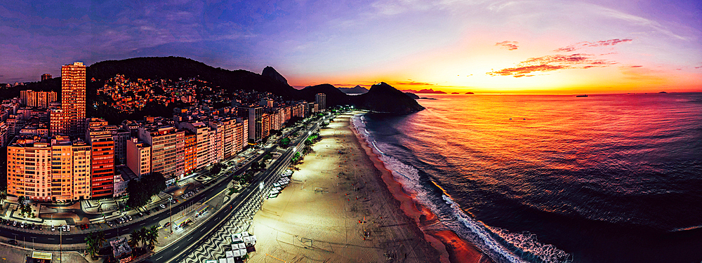 Panoramic aerial drone view of Leme Beach in the Copacabana district at sunrise with the iconic Sugarloaf Mountain in the background, UNESCO World Heritage Site, Rio de Janeiro, Brazil, South America