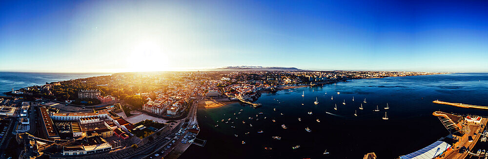 Aerial drone panoramic view of sunset at Cascais Bay, in the Lisbon region of the Portuguese Riveira, Europe