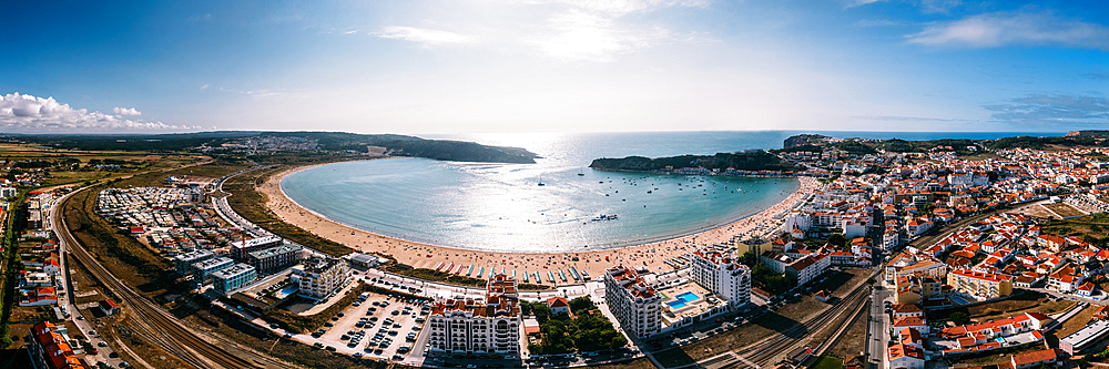 Aerial drone panoramic view of Sao Martinho do Porto bay, shaped like a scallop with calm waters and fine white sand, Oeste, Portugal, Europe