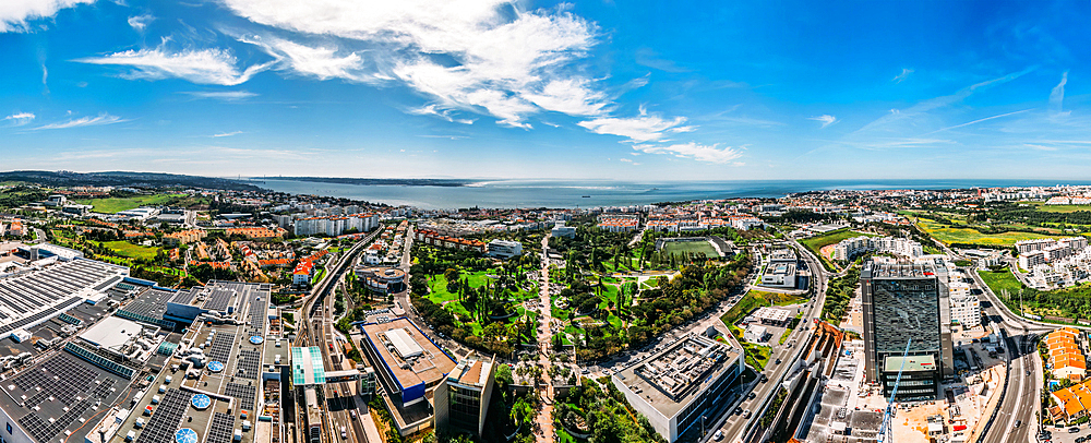 Aerial drone panoramic view of Parque dos Poetas, 25 hectare parkland with 60 statues in honour of 60 poets, Oeiras, Lisbon, Portugal, Europe