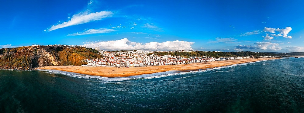 Aerial drone panoramic view of Nazare beach and Nazare city on a sunny day, Nazare, Oeste, Estremadura, Portugal, Europe