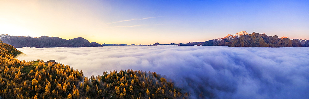 Aerial view of Malenco valley covered by fog at sunrise, Valmalenco, Valtelllina, Lombardy, Italy, Europe