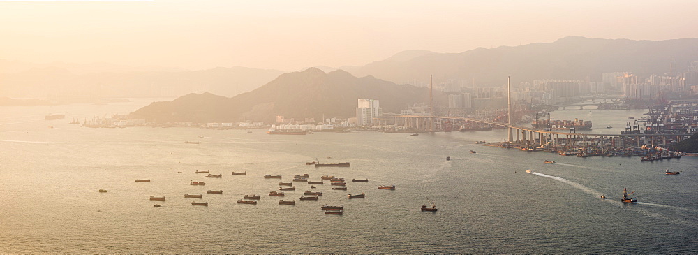 Boats in Victoria Harbour at sunset, seen from Victoria Peak, Hong Kong Island, Hong Kong, China, Asia