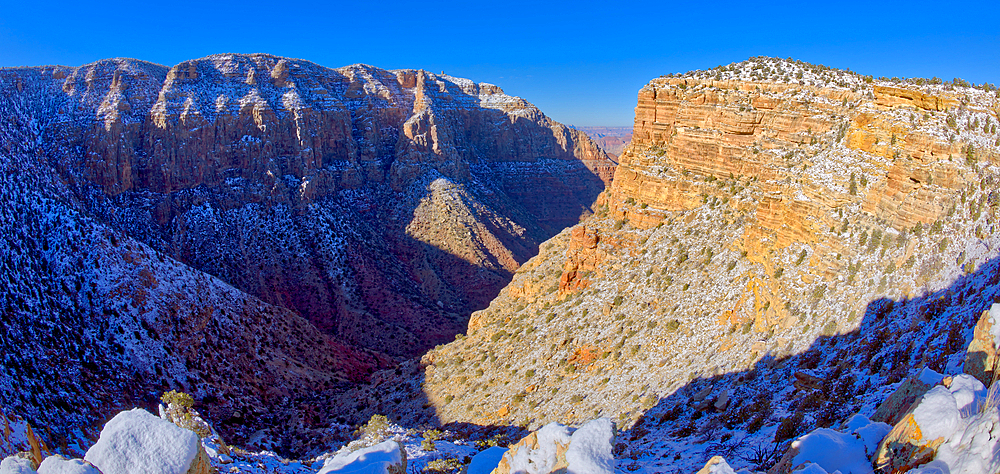 The snowy cliffs of Desert View Point on the left with the Palisades on the right at Grand Canyon National Park Arizona.